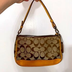 Authentic Coach Wristlet! Gorgeous little bag, orange inside with pocket.